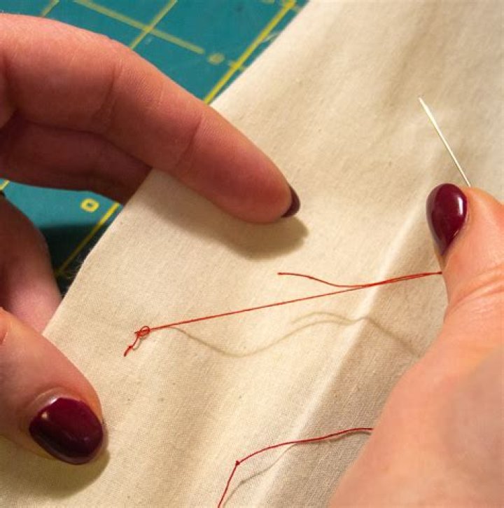 Mends with needle and thread